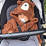 baby, baby_stroller, babywearing, bear_ears, blanket, child, clothing, cozy, cute, face, fuzzy, hoodie, infant, outdoor, pacifier, person, portrait, seatbelt, stroller, warm