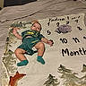 Daniel Moreno joined the competition — help win amazing prizes! baby, bed, blanket, child, clothing, cute, diaper, feet, footwear, green_outfit, head, infant, lying_down, plush_toy, sock, stuffed_animal, text, toy, woodland_design, young_child
