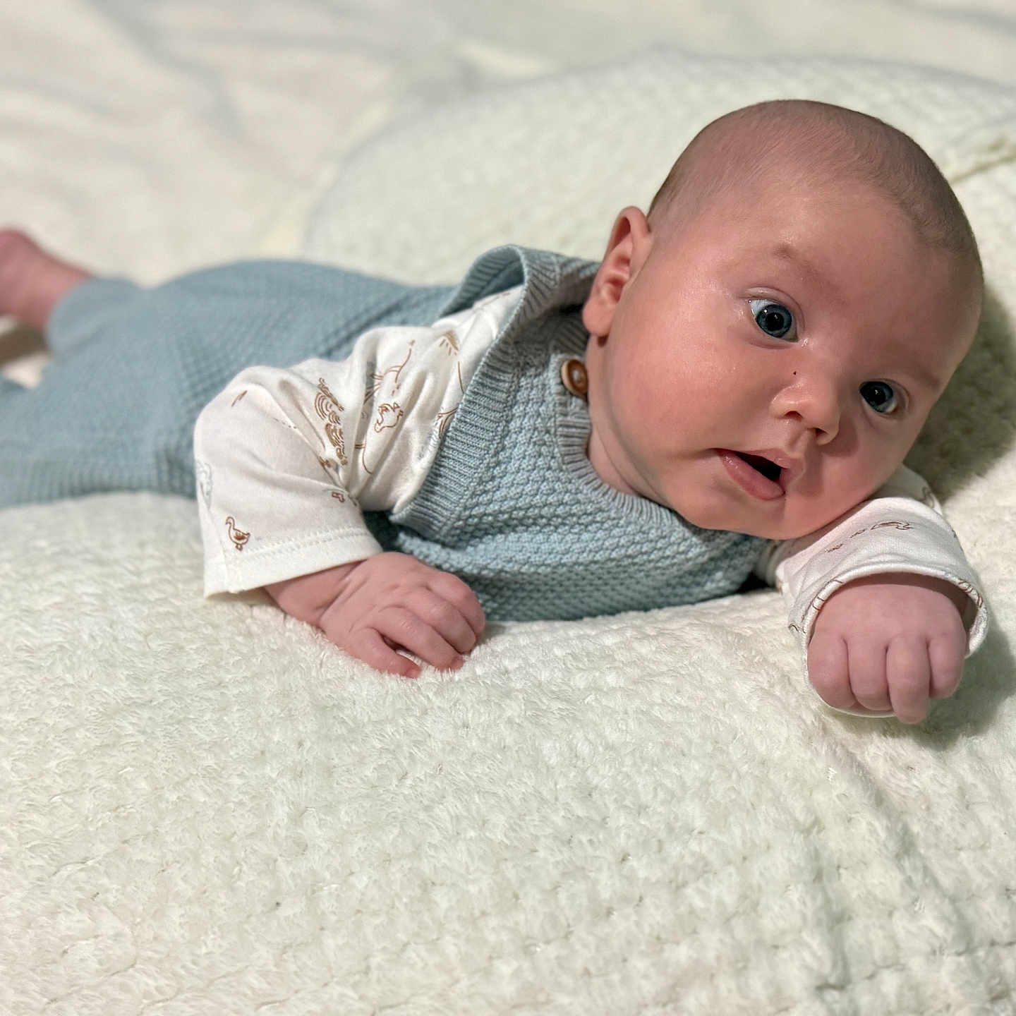 Liam is registered to the contest to win money with this photo: baby, blanket, bodypart, clothing, couch, face, finger, hand, happy, head, knitwear, longsleeve, newborn, pants, person, photography, portrait, sleeve, smile, sweater