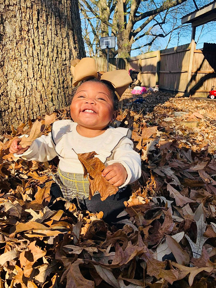 Kyla joined the competition — help win amazing prizes! baby, brown, child, daytime, deciduous, grass, happy, hat, joy, people_in_nature, person, plant, sky, soil, sunlight, tints_and_shades, toddler, tree, trunk, twig
