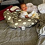 Kalani is registered to the contest to win money with this photo: baby, smiling, infant, pillow, bed, blanket, indoor, person, clothing, happy, face, child, flooring, toddler, toy, cozy, home, fabric, comfort, nursery