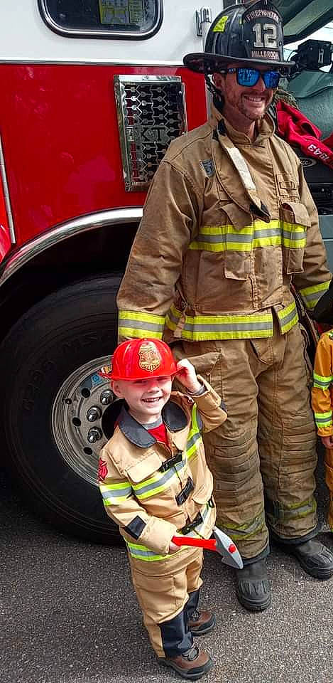 Ryder Henson is registered to the contest to win money with this photo: automotive_tire, blue_collar_worker, emergency_service, event, fire_apparatus, fire_department, firefighter, gas, hard_hat, headwear, helmet, high_visibility_clothing, joy, motor_vehicle, person, personal_protective_equipment, red, rescuer, service, tire