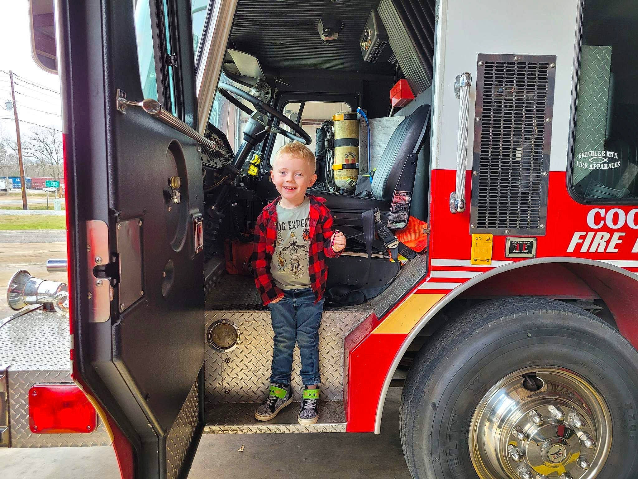 Ryder Henson is registered to the contest to win money with this photo: asphalt, auto_part, automotive_design, automotive_exterior, automotive_tire, automotive_wheel_system, commercial_vehicle, fender, firefighter, gas, jacket, joy, mode_of_transport, motor_vehicle, person, service, smile, tire, tread, truck