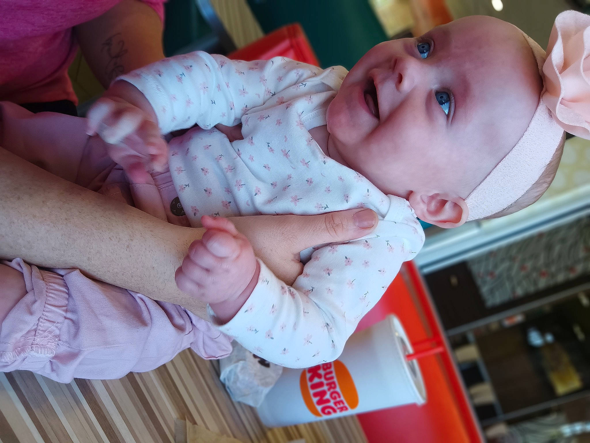 Miriam is registered to the contest to win money with this photo: baby, baby_products, baby_toddler_clothing, cheek, child, comfort, finger, gesture, nail, pattern, person, pink, sitting, skin, sleeve, thumb, toddler, white