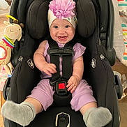 Aleigha joined the competition — help win amazing prizes! baby, car_seat, child, cute, flower, footwear, happy, headband, home, indoor, infant, person, playful, plush_toy, purple_outfit, seat_belt, smile, sock, toy, wood_floor