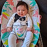 baby, infant, smile, happy, sitting, baby_rocker, clothing, animal_print, colorful, pattern, face, hair, indoors, toy, plush_toy, comfort, cute, child, person, seat