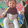 baby, infant, smiling, baby_rocker, toy, plush_toy, flower_toy, overalls, white_clothing, indoor, couch, happy, child, face, legs, colorful, playful, cute, seated, home