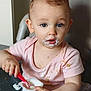Elizabeth participe au concours pour gagner de l'argent avec cette photo : child, baby, toddler, yogurt, mess, high_chair, spoon, food, face, milk_mustache, pink_shirt, hand, closeup, portrait, eating, mealtime, indoor, stains, curious_eyes, tray