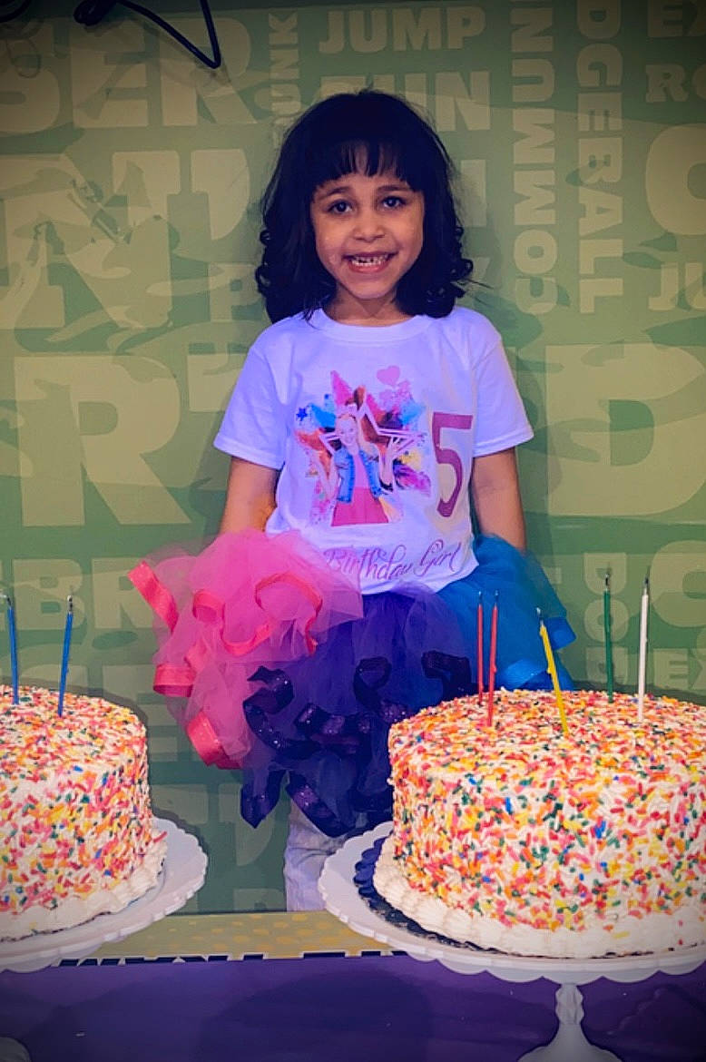 Nalayah is registered to the contest to win money with this photo: baked_goods, birthday, birthday_cake, birthday_party, cake, cake_decorating, cake_decorating_supply, candle, cuisine, face, food, happy, joy, person, pink, purple, smile, sugar_cake, table, tableware