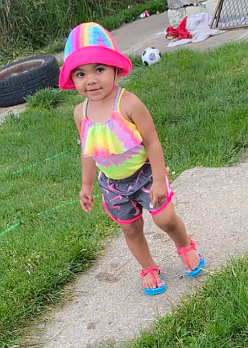 Nylianne joined the competition — help win amazing prizes! child, event, face, fun, grass, happy, headwear, joy, lawn, leisure, magenta, people_in_nature, person, personal_protective_equipment, pink, plant, recreation, shorts, smile, summer