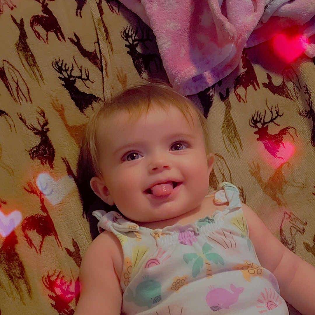 Tissaia joined the competition — help win amazing prizes! baby, blanket, child, colorful_clothing, cute, deer_pattern, happy, heart_lights, indoor, infant, lying_down, palm_tree_print, pink_blanket, playful, portrait, smiling, soft_texture, striped_shorts, tongue_out, whale_print