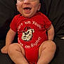 baby, infant, smiling, red_onesie, sitting, happy, face, barefoot, chubby_legs, cute, indoors, portrait, child, clothing, expression, skin, person, young, head, background