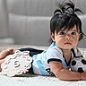 baby, infant, child, portrait, lying_down, soccer_ball, milestone_sign, five_months, dark_hair, pigtails, wide_eyes, indoor, play_mat, baby_clothing, blue_shirt, smiling, calm, photography, family_milestone, cute