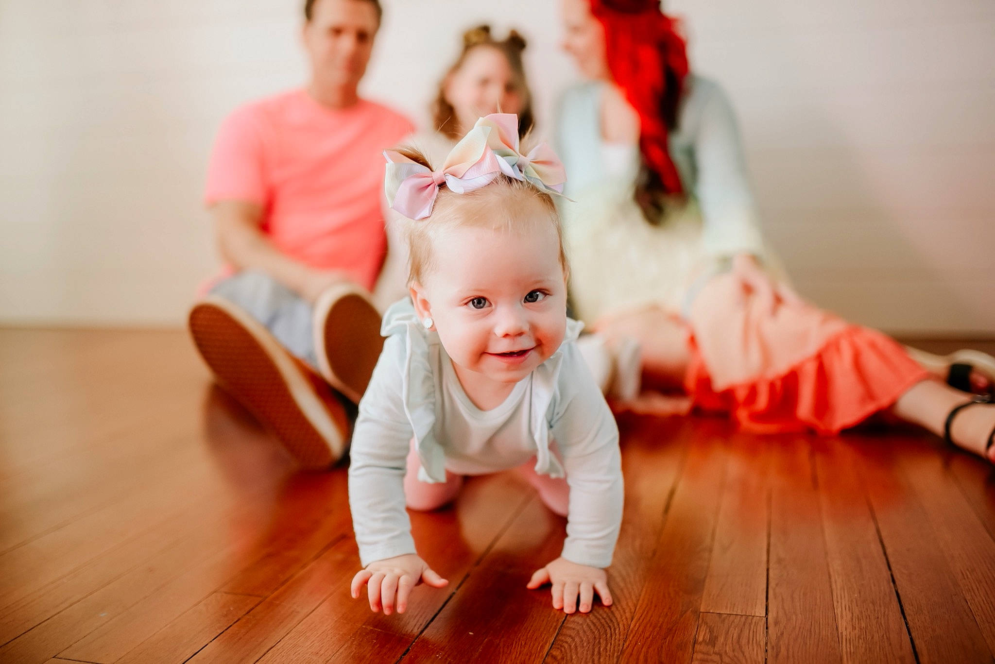 Indie is registered to the contest to win money with this photo: baby, baby_toddler_clothing, blurred, child, event, flash_photography, floor, flooring, fun, happy, hardwood, joy, laminate_flooring, person, sitting, skin, smile, t_shirt, toddler, varnish
