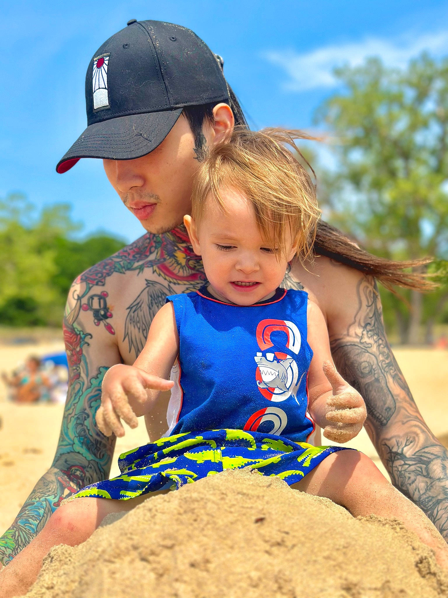 Caspian is registered to the contest to win money with this photo: arm, baseball_cap, beach, cap, cloud, facial_expression, fun, hand, happy, hat, headwear, human, leisure, mammal, people_in_nature, people_on_beach, person, sky, summer, t_shirt