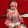 baby, child, smiling, pink, headband, bow, toy, ring, couch, red, plush, elephant, cute, happy, infant, person, clothing, sitting, indoors, play