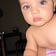 Eitham is registered to the contest to win money with this photo: baby, infant, child, portrait, close_up, face, eyes, wide_eyed, indoors, home, dining_area, table, chair, towel, pink_stripes, bare_shoulders, sitting, curious, flash_photography, photograph