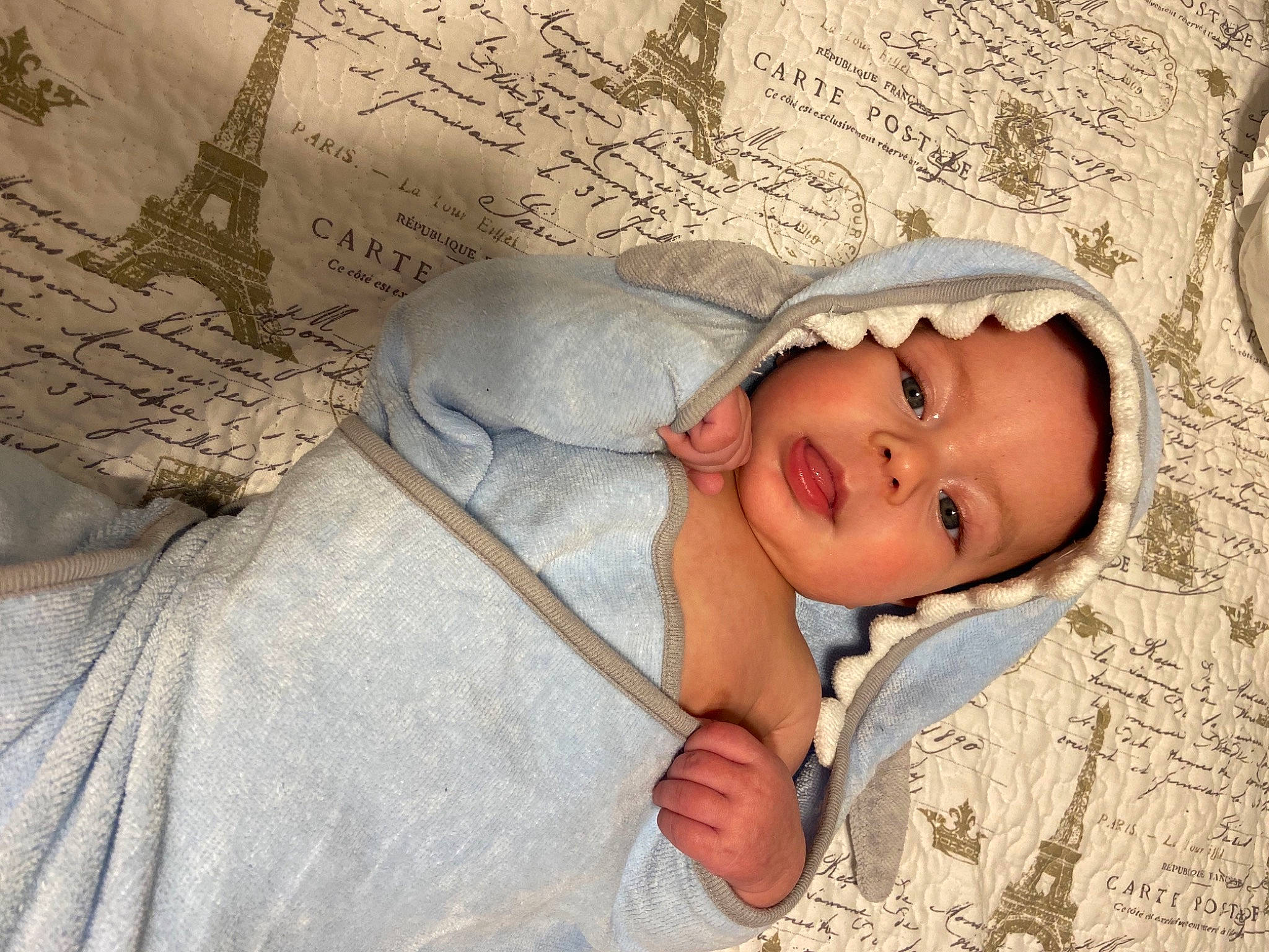 Kallum is registered to the contest to win money with this photo: baby, baby_toddler_clothing, bedding, cheek, comfort, eye, hand, happy, head, headgear, human_body, linens, lip, mouth, nose, person, skin, smile, textile, toddler