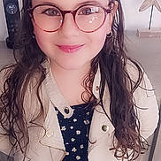 Elena a rejoint le concours — aidez-le/la à gagner de superbes lots ! accessory, casual, child, curly_hair, decor, face, fashion, floral_top, girl, glasses, hair, happy, indoor, jacket, long_hair, person, portrait, smiling, standing, young