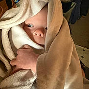 Paxtyn joined the competition — help win amazing prizes! baby, towel, wrapped, hand, face, indoor, curious, clothing, skin, person, child, infant, soft_texture, peek, light, shadow, cozy, warm, blanket, portrait
