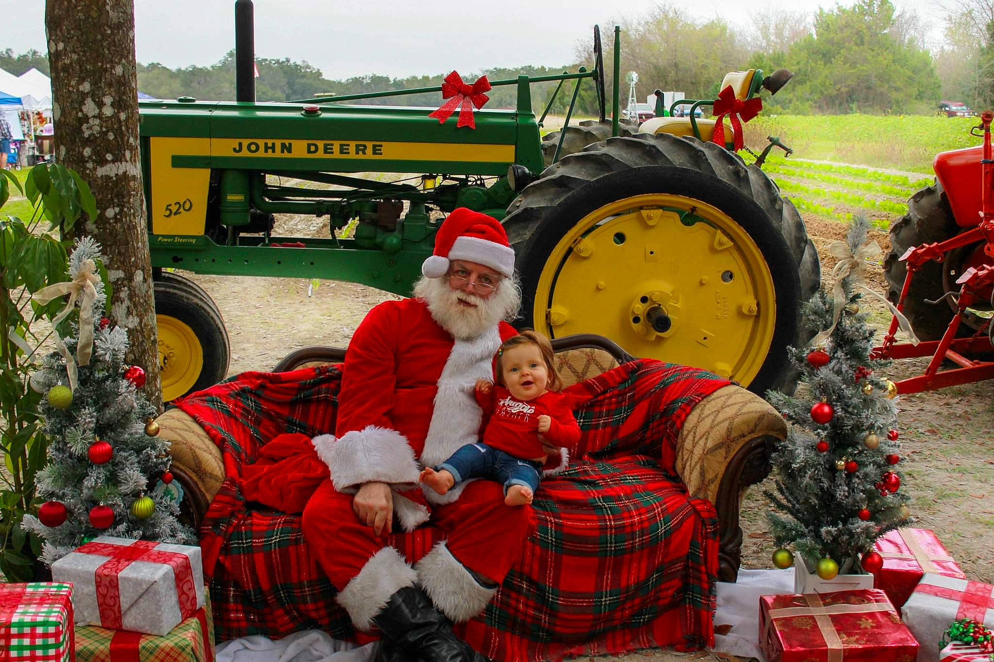 Iyla joined the competition — help win amazing prizes! agricultural_machinery, agriculture, automotive_tire, christmas_ornament, event, farmer, grass, green, headwear, mammal, motor_vehicle, person, plaid, plant, rolling, sky, tartan, tire, tractor, tree