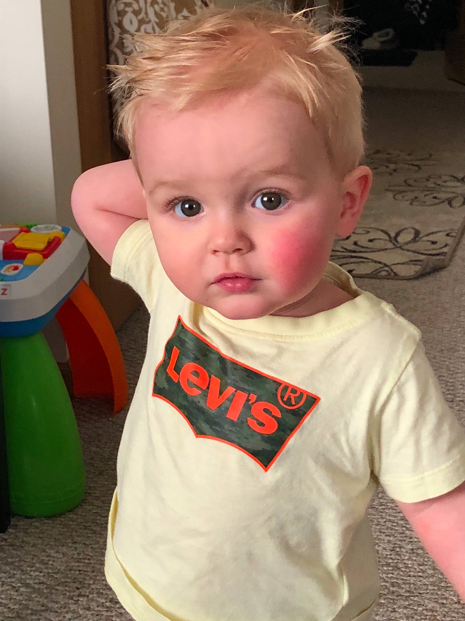 Watson is registered to the contest to win money with this photo: baby, baby_toddler_clothing, cheek, child, chin, cool, ear, eye, face, forehead, hair, hairstyle, head, neck, nose, person, skin, sleeve, standing, t_shirt
