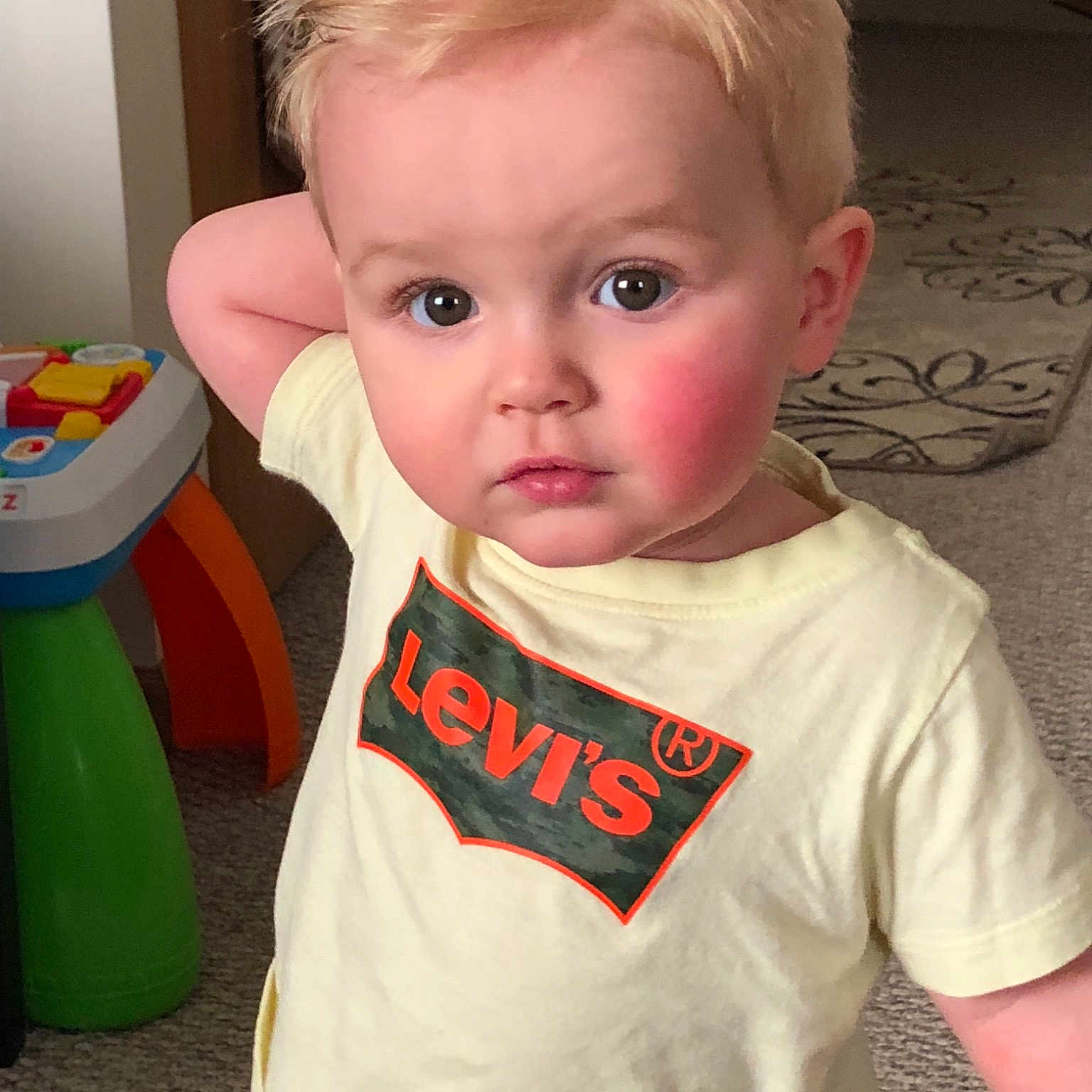 Watson is registered to the contest to win money with this photo: baby, baby_toddler_clothing, cheek, child, chin, cool, ear, eye, face, forehead, hair, hairstyle, head, neck, nose, person, skin, sleeve, standing, t_shirt