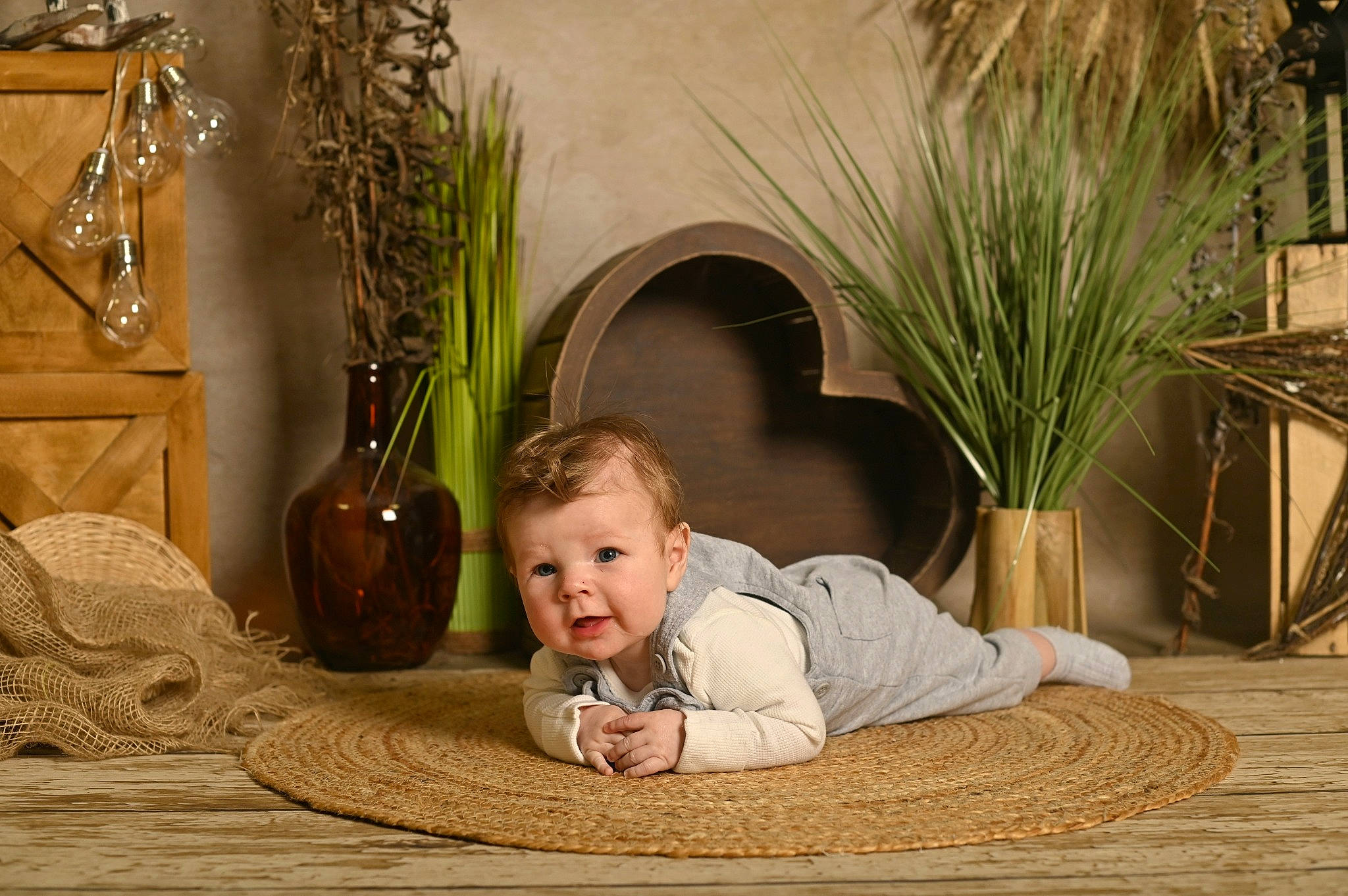 Caleb is registered to the contest to win money with this photo: baby, baby_toddler_clothing, comfort, floor, flooring, grass, happy, hardwood, linens, person, plant, rectangle, room, serveware, sitting, smile, textile, toddler, twig, wood