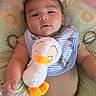 Ayden joined the competition — help win amazing prizes! baby, baby_bib, bib, child, clothing, comfort, cushion, cute, duck, face, hand, indoors, infant, lying_down, pattern, plush_toy, portrait, smile, soft_toy, toy
