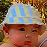 baby, child, face, bucket_hat, hat, outdoor, portrait, curious, pouty, skin, ear, cheek, headwear, summer, young_child, person, expression, closeup, natural_light, infant