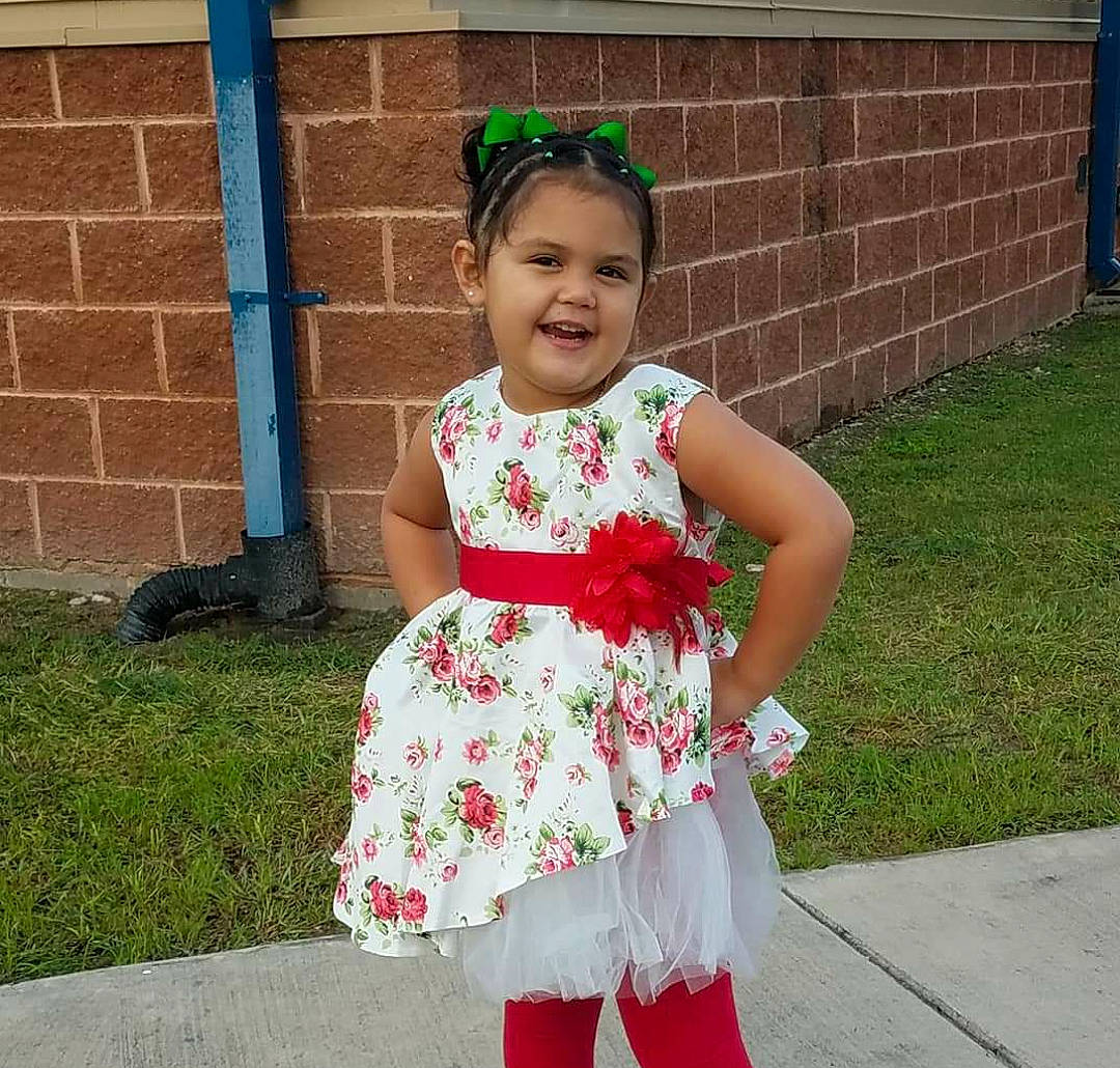 Aliah joined the competition — help win amazing prizes! baby_toddler_clothing, child, clothing, costume, dress, flower, hair_accessory, joy, pattern, person, petal, plant, smile, toddler