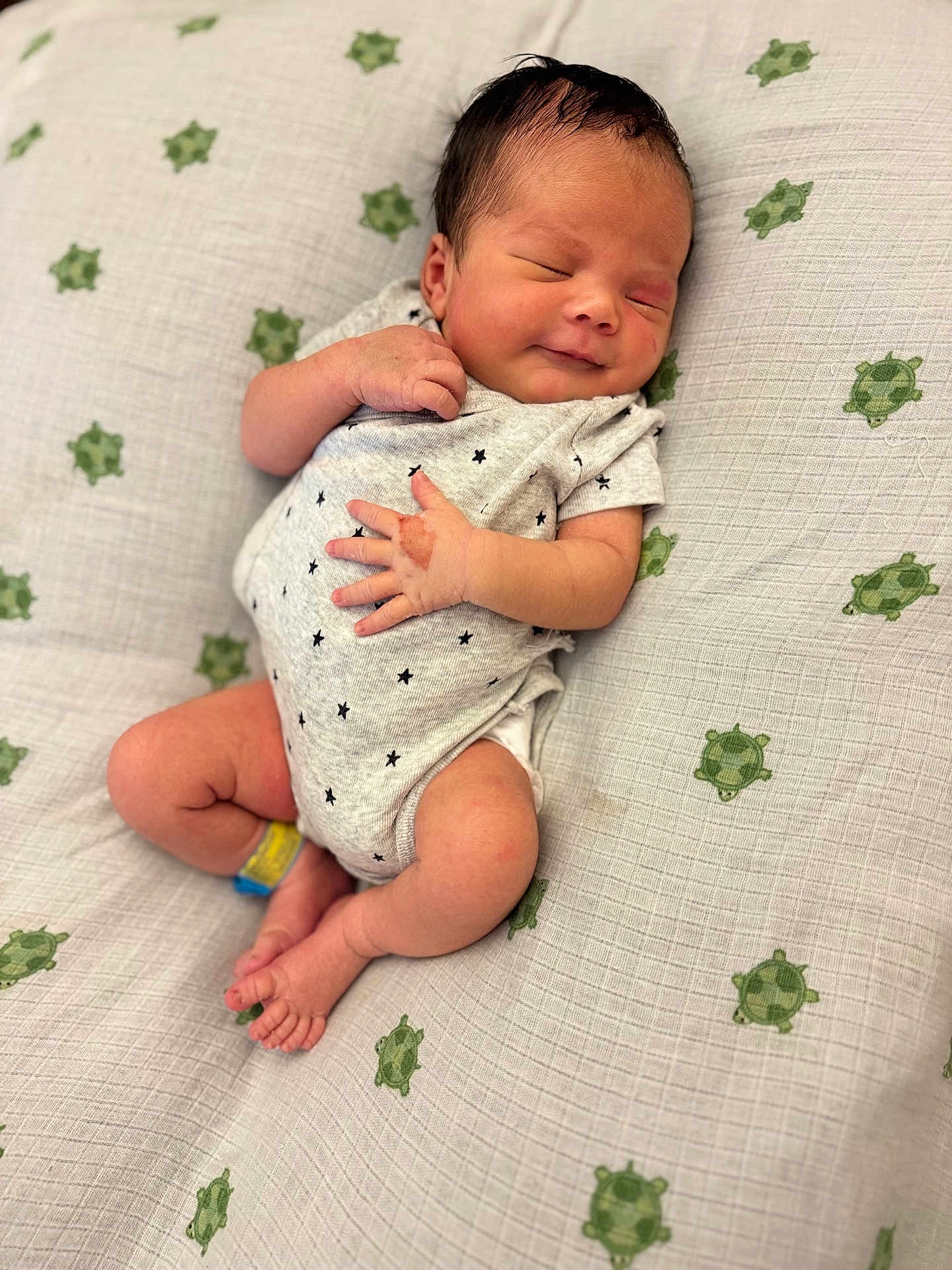 Maëlan participe au concours pour gagner de l'argent avec cette photo : newborn, baby, infant, smile, sleeping, blanket, turtle_pattern, onesie, cute, peaceful, soft_lighting, indoor, small_hands, small_feet, lying_down, portrait, child, sleep, happy, cozy