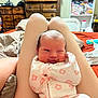 Oaklynn is registered to the contest to win money with this photo: baby, infant, onesie, smile, winking, legs, bedroom, furniture, dresser, blanket, person, cute, home, sleepwear, newborn, resting, pink, pattern, cozy, indoor