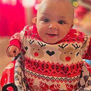 Raiylond Jr is registered to the contest to win money with this photo: baby, child, smiling, sweater, reindeer_pattern, red, white, baby_walker, indoor, holiday, christmas, festive, cute, portrait, happy, infant, face, seat, toy, blurred_background