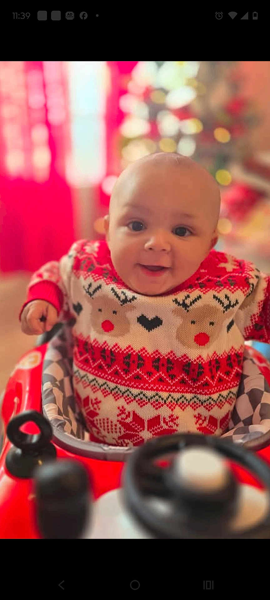 Raiylond Jr is registered to the contest to win money with this photo: baby, child, smiling, sweater, reindeer_pattern, red, white, baby_walker, indoor, holiday, christmas, festive, cute, portrait, happy, infant, face, seat, toy, blurred_background
