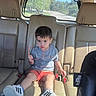Abel joined the competition — help win amazing prizes! child, boy, car_interior, seat, sunglasses, curious, leather_seat, casual_clothing, shorts, tshirt, sneakers, daylight, window, seatbelt, car_backseat, road_outside, sunlight, curly_hair, footwear, vehicle