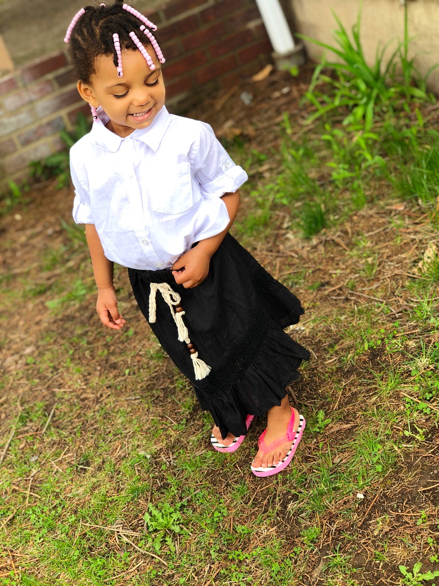 Kamri is registered to the contest to win money with this photo: child, clothing, dress, fun, girl, grass, joy, outerwear, pattern, person, smile, toddler