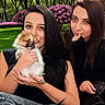 Bella is registered to the contest to win money with this photo: black_clothing, casual, cute, dog, flower, friendship, garden, grass, greenery, happy, holding, long_hair, nature, outdoor, pet, pomeraian, portrait, relaxation, smile, woman