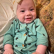 Lydia Faye Anne is registered to the contest to win money with this photo: baby, child, smiling, headband, onesie, polka_dots, couch, pillow, indoor, infant, clothing, cute, happy, portrait, sitting, hand, face, person, fabric, cozy