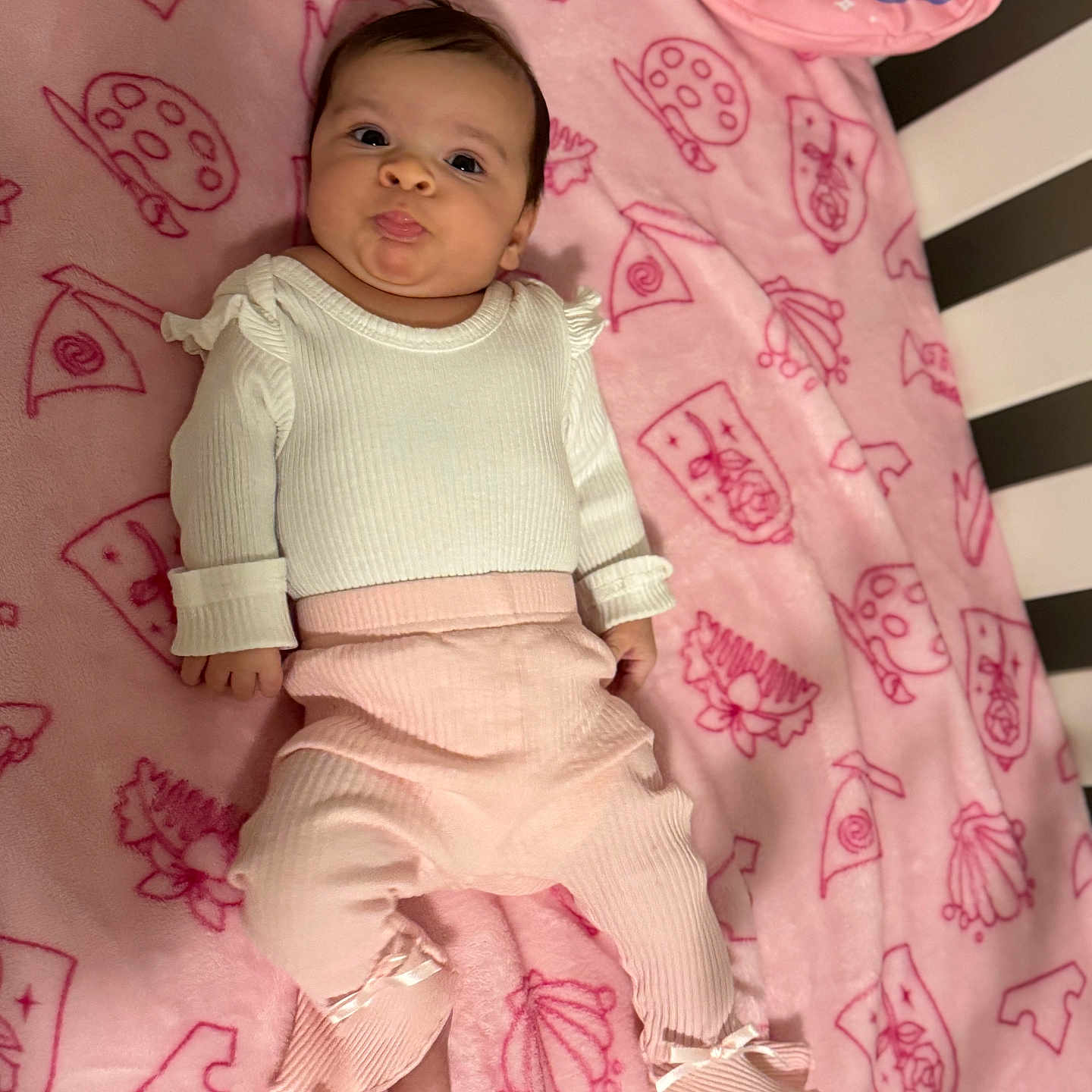 Lannah joined the competition — help win amazing prizes! baby, blanket, child, crib, cute, face, indoor, infant, lying_down, newborn, pants, pattern, person, pink, playful, ribbon, sleeping_area, soft_texture, tongue_out, white_clothing