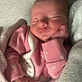 newborn, baby, sleeping, pink_clothing, blanket, infant, peaceful, hand, face, soft_texture, cozy, cute, indoors, portrait, closeup, child, young, wrapped, resting, toddler