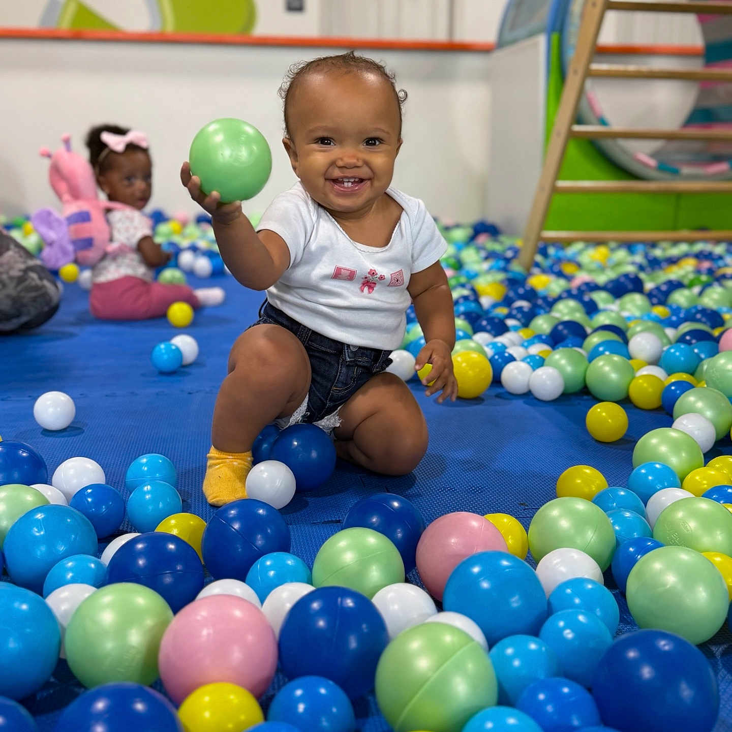 Savannah is registered to the contest to win money with this photo: baby, background, ball_pit, balls, child, clothing, colorful, floor, fun, happy, indoor, kid, person, play, playground, shorts, smiling, socks, toddler, toy