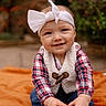 baby, child, smiling, headband, bow, plaid, vest, jeans, shoes, blanket, outdoor, nature, greenery, blurred_background, happy, cute, portrait, sitting, toddler, hand
