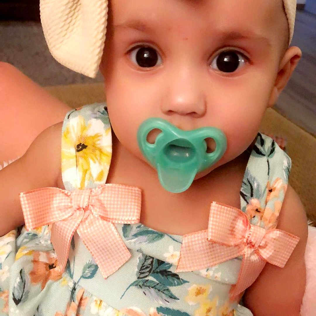 Loyalty is registered to the contest to win money with this photo: accessories, baby, bonnet, cap, clothing, costume, couch, doll, dress, earring, face, furniture, hat, head, homedecor, person, photography, portrait, sitting, toy