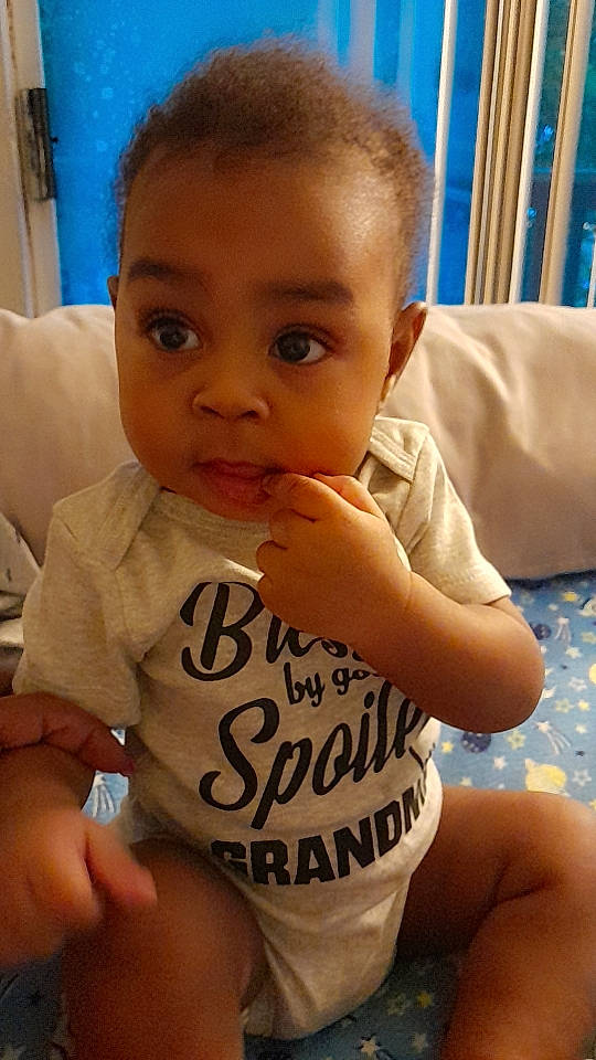 Cayden is registered to the contest to win money with this photo: baby_toddler_clothing, blue, cheek, chin, ear, eye, eyebrow, eyelash, face, facial_expression, forehead, hair, hand, head, lip, mouth, neck, nose, person, skin