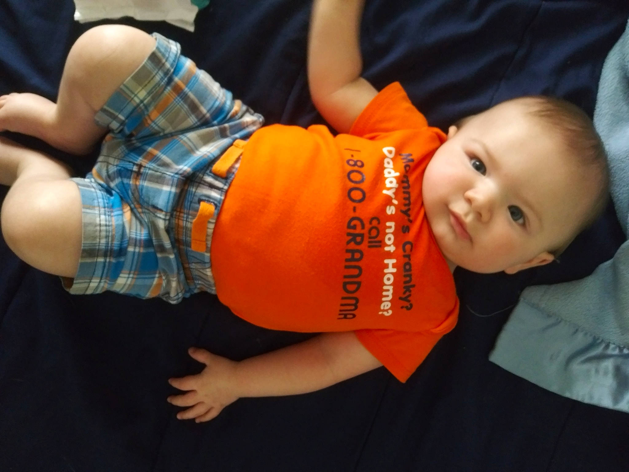 James is registered to the contest to win money with this photo: abdomen, clothing, elbow, finger, fun, gesture, happy, human_body, joint, knee, leg, mouth, nail, orange, person, skin, sleeve, smile, t_shirt, thigh