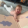 Lùna participe au concours pour gagner de l'argent avec cette photo : baby, infant, smiling, play_mat, indoor, floor, toy, crawling, child, happy, cute, cozy, clothing, furniture, cabinet, home, person, expression, playtime, toddler