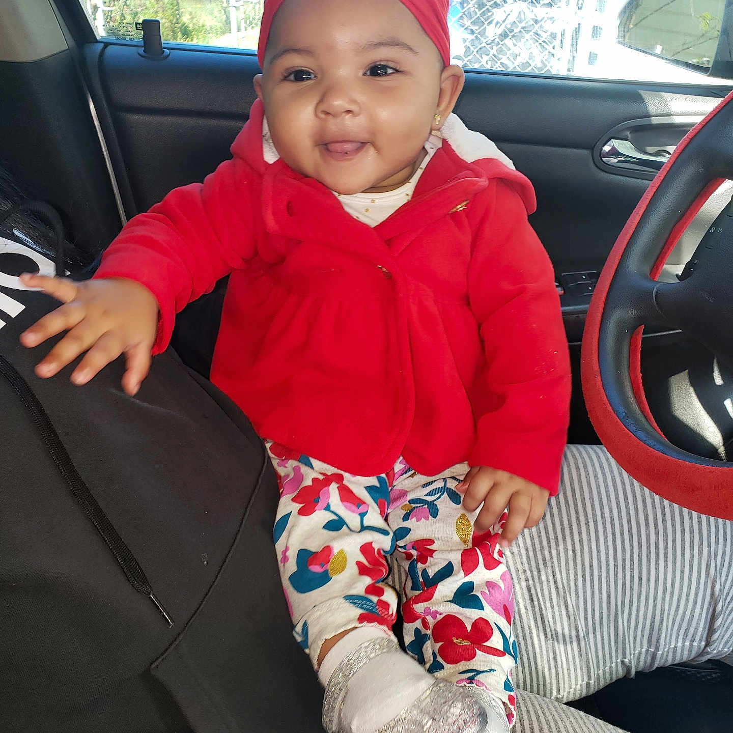 Aniyah is registered to the contest to win money with this photo: alloywheel, baby, baseballcap, cap, clothing, coat, cushion, face, footwear, hat, head, homedecor, jacket, pants, person, photography, portrait, shoe, sitting, sneaker