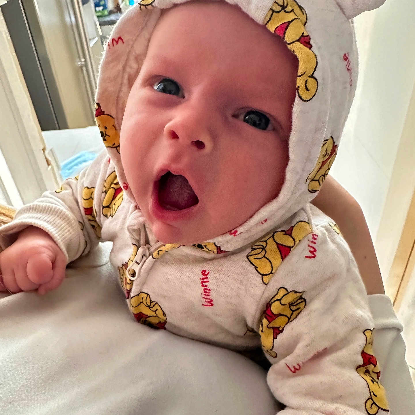 Pedro is registered to the contest to win money with this photo: baby, casual, child, clothing, cute, expression, fabric, face, hand, holding, hoodie, indoor, infant, person, portrait, sleeve, soft, warm, winnie_the_pooh, young_child
