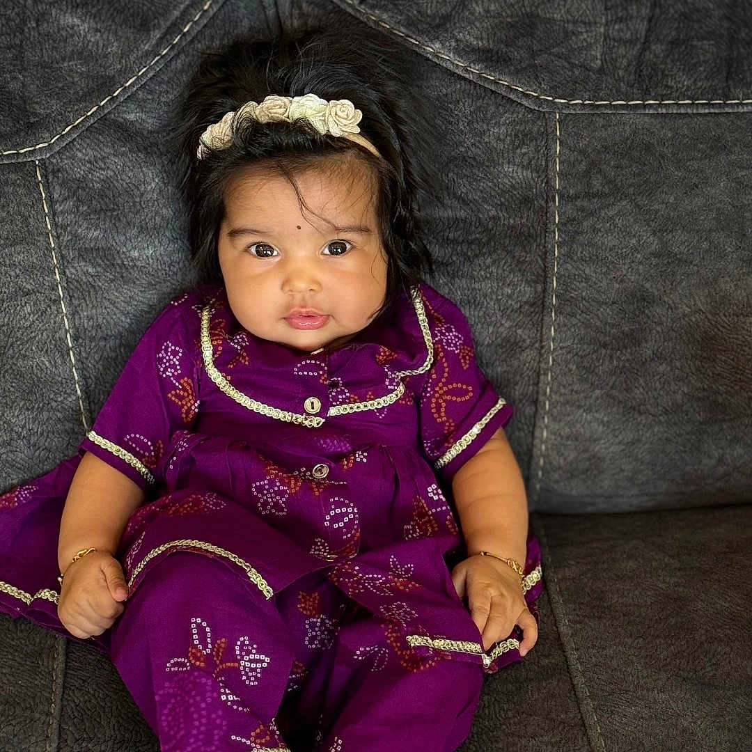 Airaa is registered to the contest to win money with this photo: baby, child, couch, cozy, cute, decor, face, fashion, feet, hand, happy, headband, indoor, infant, portrait, purple_clothing, sitting, smiling, texture, young_child